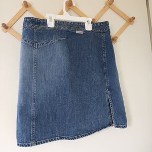 Calvin Klein size 4 jean skirt with side slit. Used good condition.